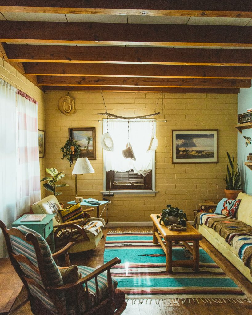 Gallery wall of mismatched frames and vintage prints styled in a cozy farmhouse home