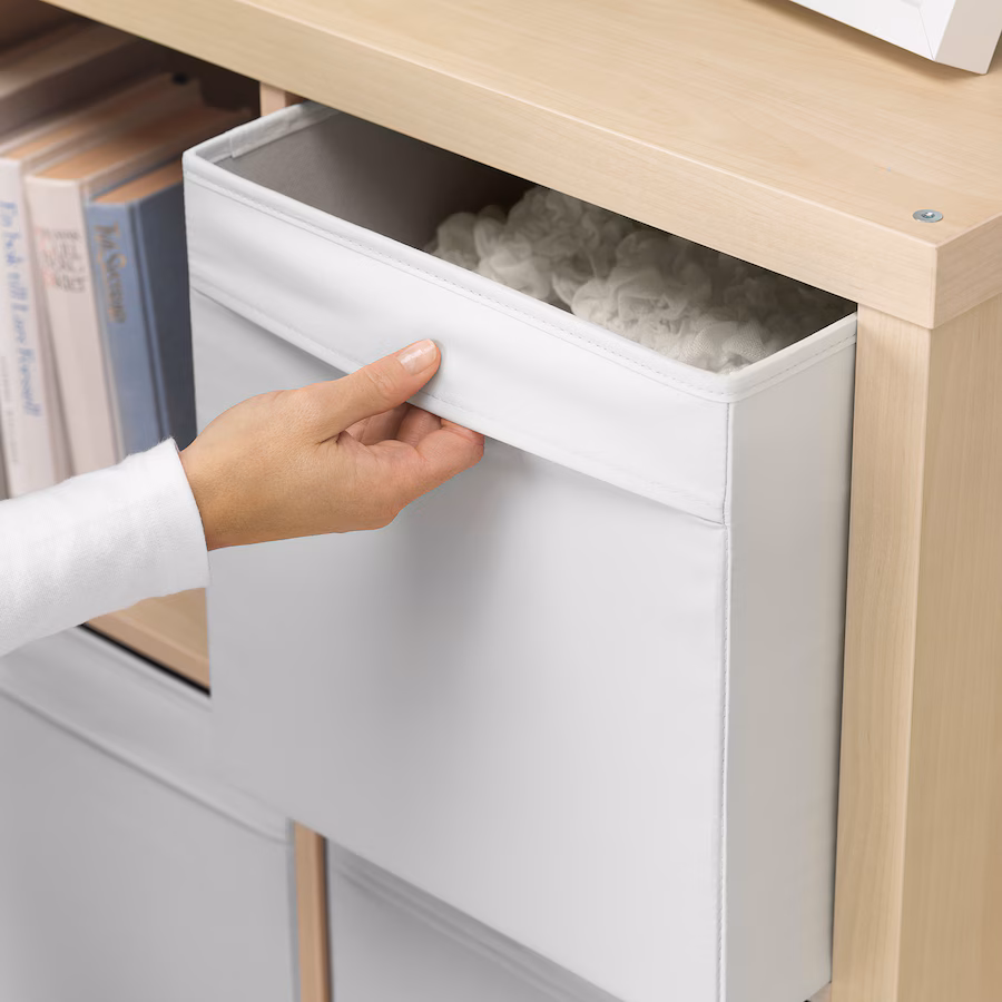 This fabric storage box combines style and practicality, whether placed in a bookshelf or walk-in closet. Designed to fit the KALLAX shelving unit, it's made primarily from recycled polyester. (Source: IKEA)