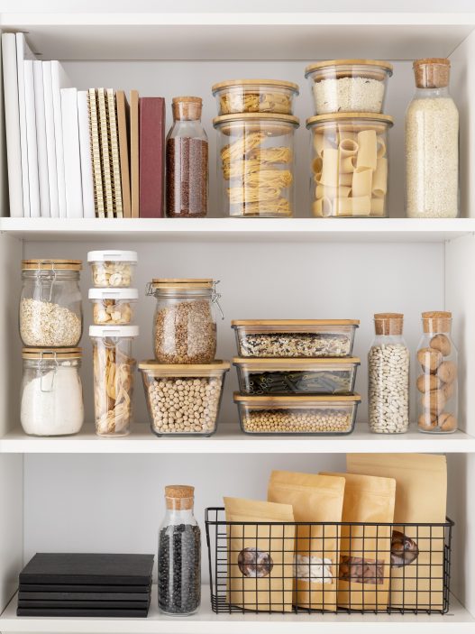 Modern kitchen with open shelving displaying stylish cookware and decor.