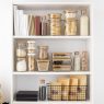 Modern kitchen with open shelving displaying stylish cookware and decor.