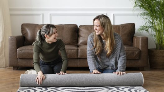 A cozy living room with a correctly sized area rug under the furniture