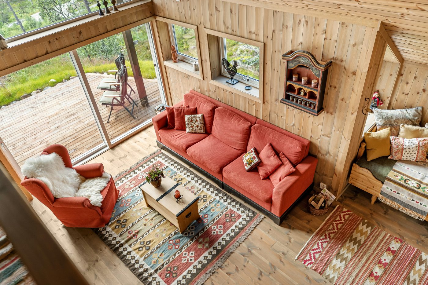 Farmhouse-style living room with rustic wall decor including wooden signs, shiplap, and greenery