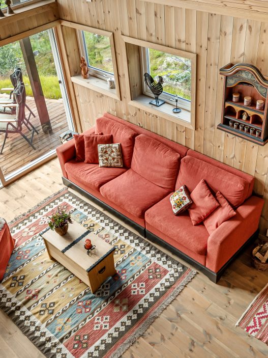Farmhouse-style living room with rustic wall decor including wooden signs, shiplap, and greenery