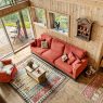 Farmhouse-style living room with rustic wall decor including wooden signs, shiplap, and greenery