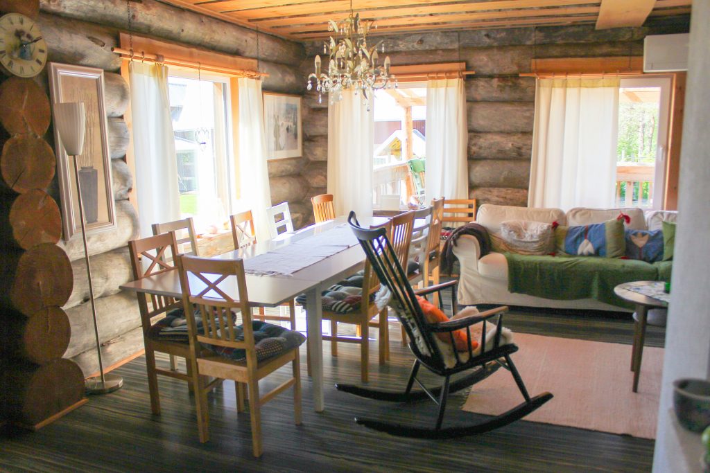 Large vintage-style farmhouse clock mounted on a shiplap wall