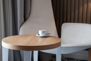 Seven modern coffee tables under $150 showcasing various styles, including minimalist, glass & chrome, mid-century, industrial, and more.