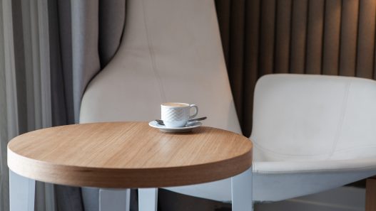 Seven modern coffee tables under $150 showcasing various styles, including minimalist, glass & chrome, mid-century, industrial, and more.
