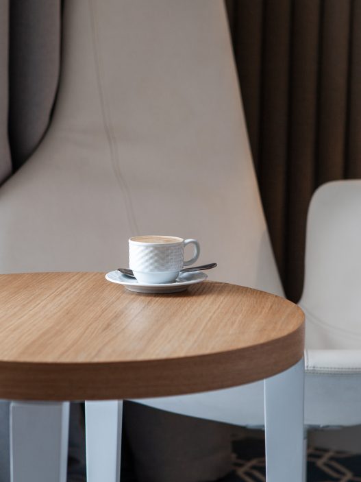 Seven modern coffee tables under $150 showcasing various styles, including minimalist, glass & chrome, mid-century, industrial, and more.