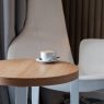 Seven modern coffee tables under $150 showcasing various styles, including minimalist, glass & chrome, mid-century, industrial, and more.