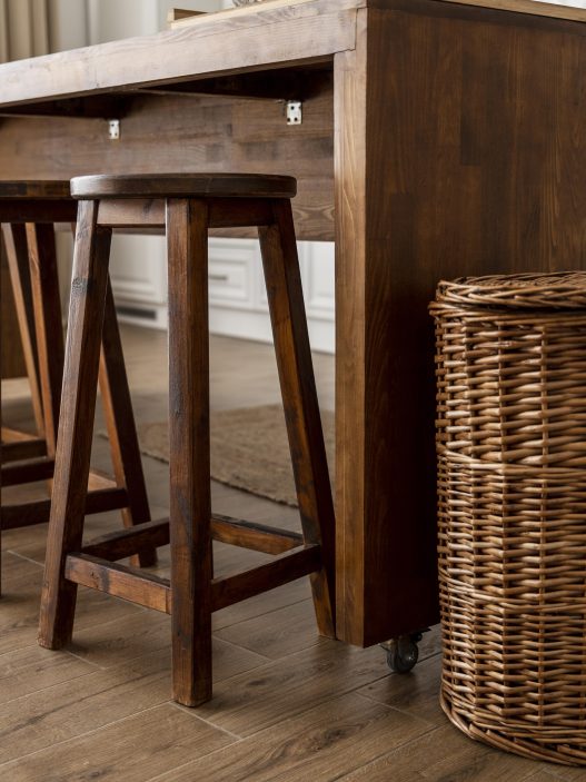 Affordable modern bar stools under $100 lined up at a kitchen island
