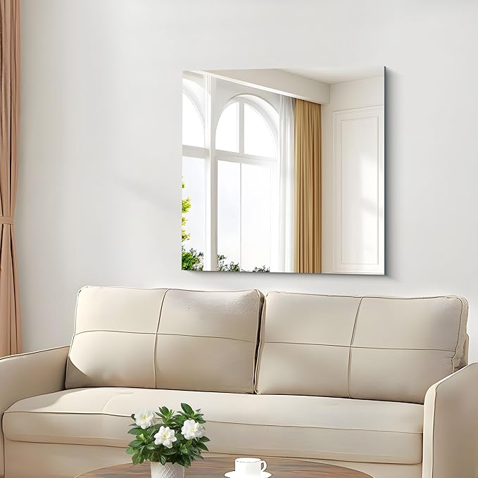 Large wall mirror reflecting window light in a compact living room to create depth