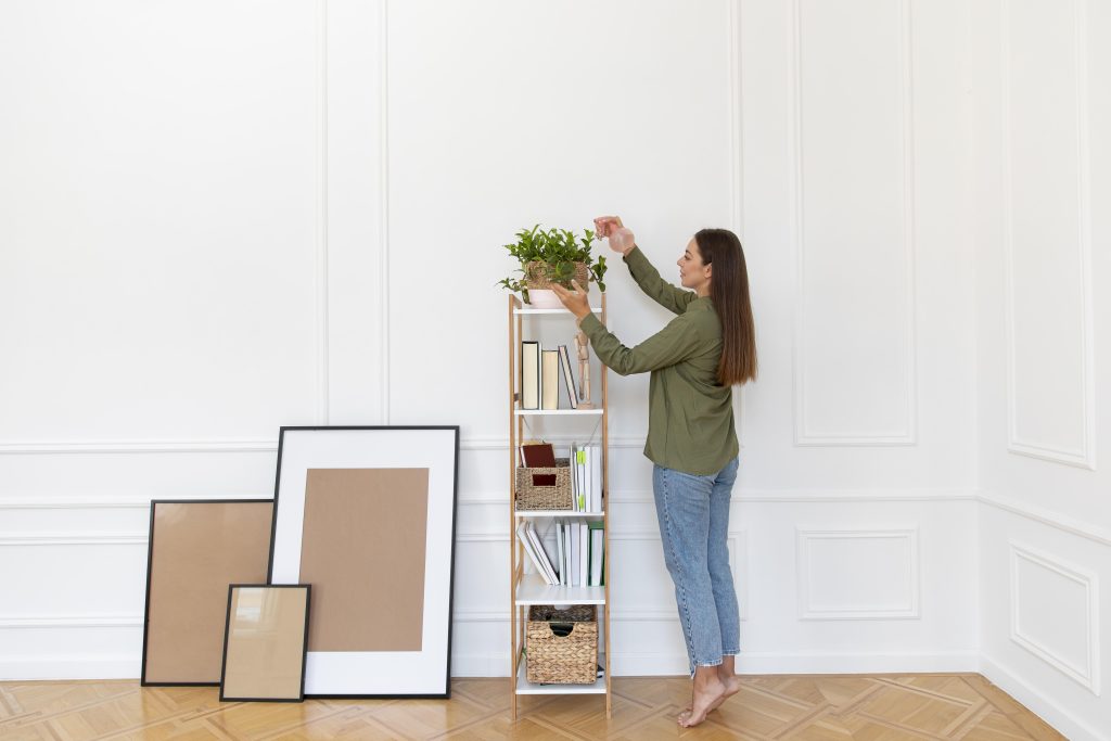 Tall bookshelf and high-mounted curtains in a small living room to maximize vertical space